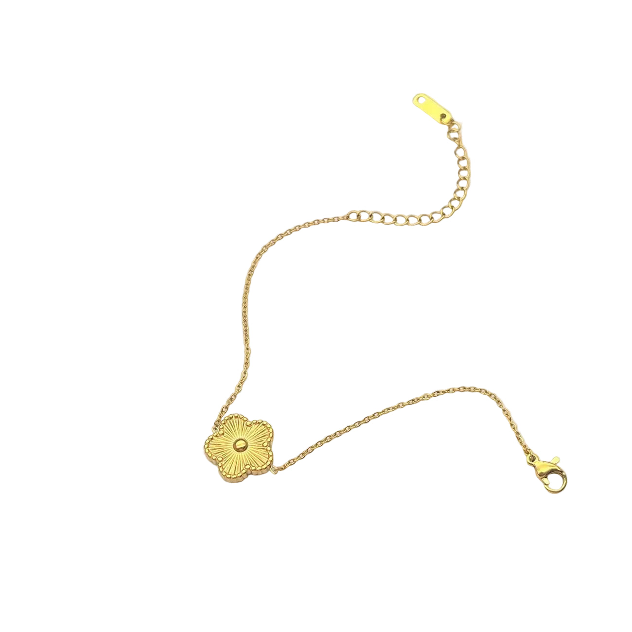 Gold bracelet with a floral clasp on a light gray background