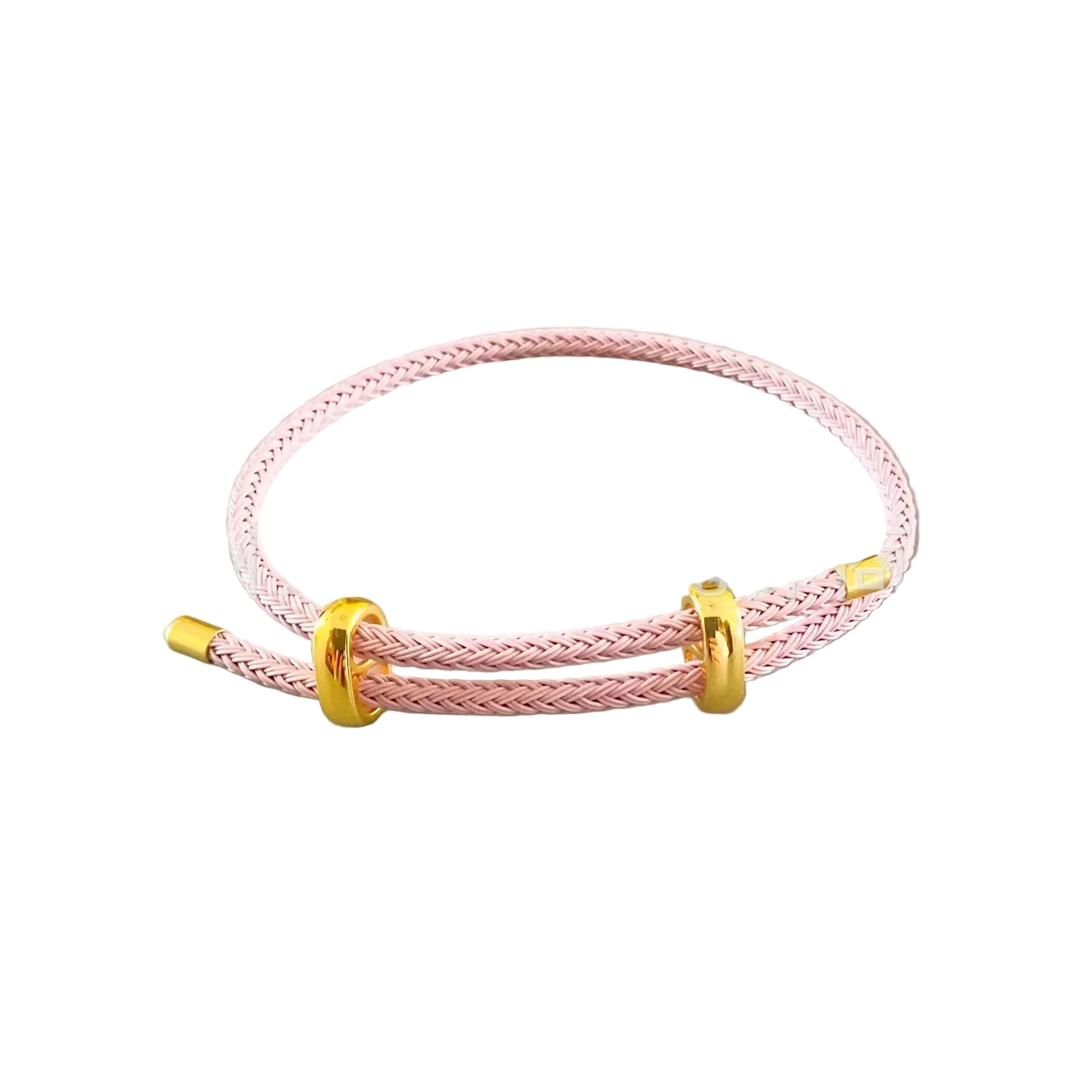 Pink braided bracelet with gold accents on a light gray background