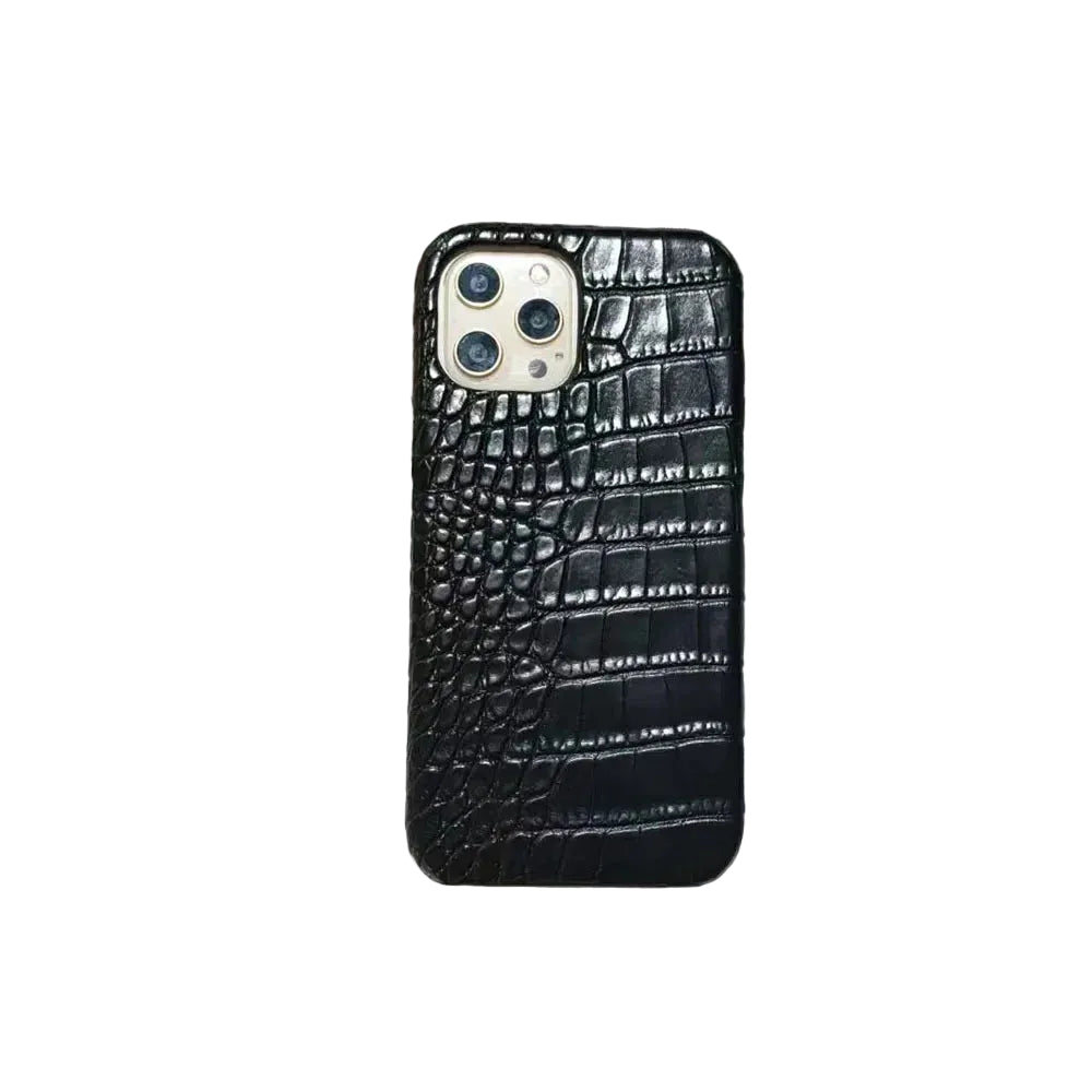 Phone case with crocodile texture on a surface with newspaper in the background